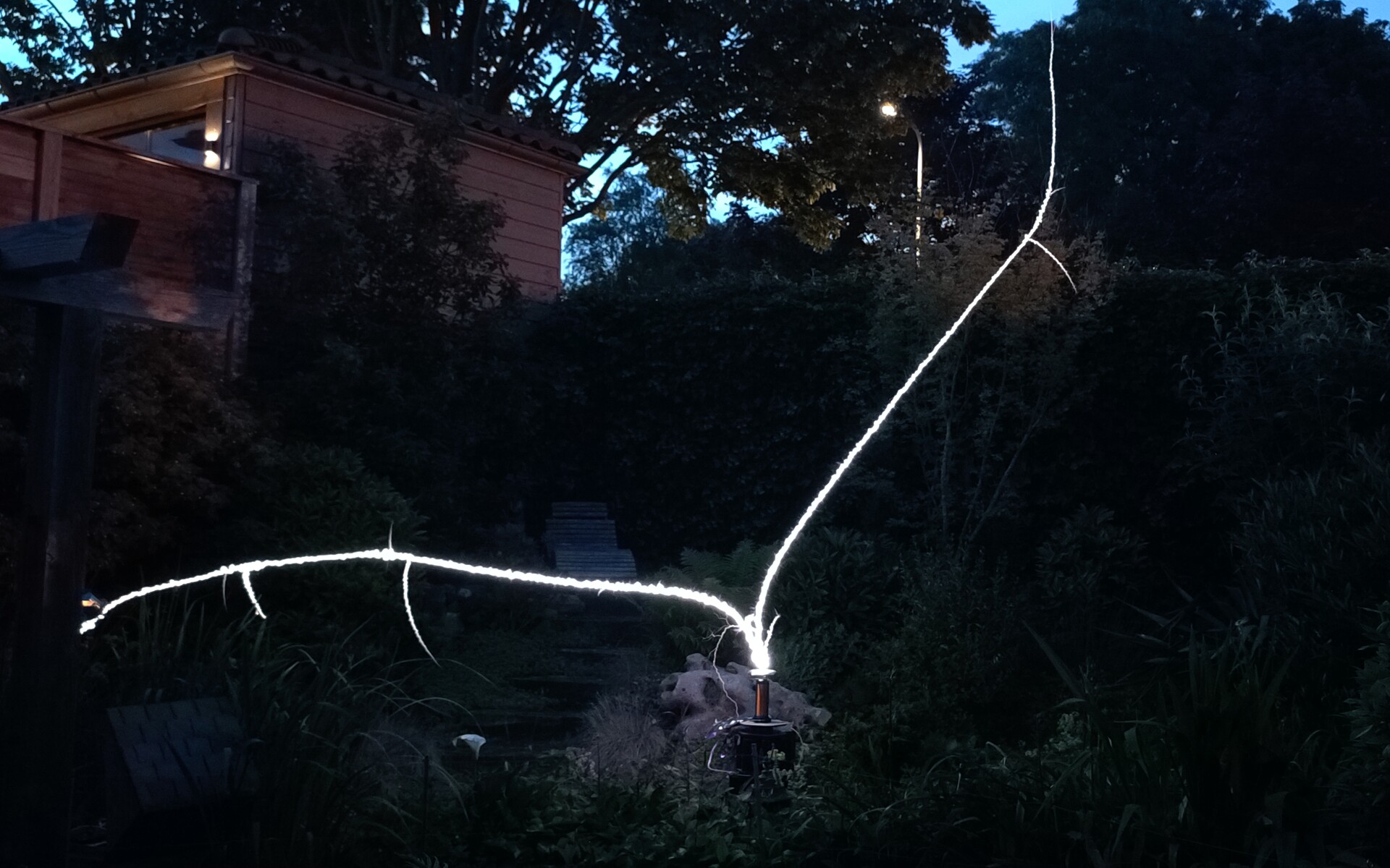 the record shot: two arcs across a garden at dusk